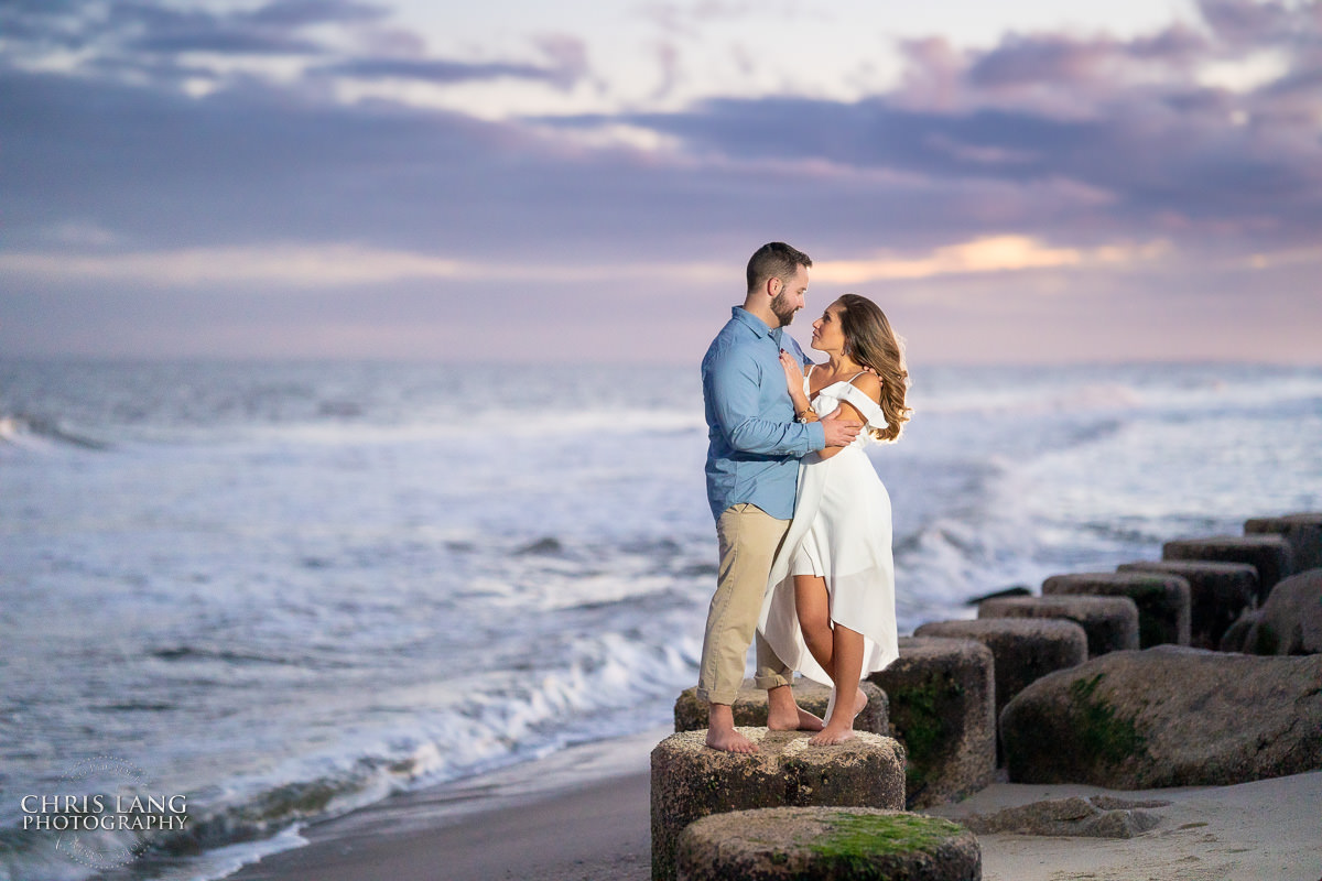Fort Fisher Wedding Photographers  - Couple Photo on the beach at sunset - Fort Fisher North Carolina -  Engagement Photography - Popular engagement photography locations - Lifestyle engagement photography -  Ft Fisher engagement photographers - Engagement session ideas - Trends in engagement photography - Chris Lang Photography - Engagement photos 