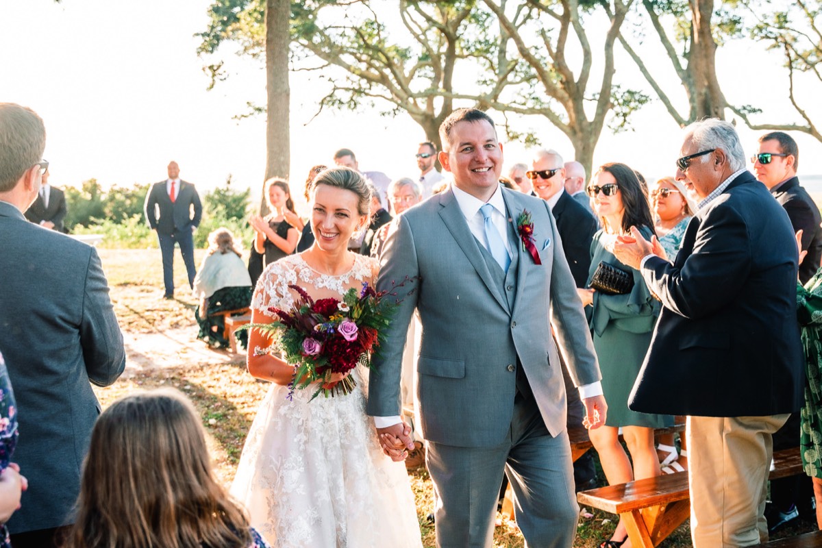 Fort Fisher Wedding Photographers - Ft Fisher Wedding Photography  - Bride & groom walking down the isle  - outdoor weddings -   Fort Fisher North Carolina -  Wedding Photography - Wedding Ideas - Bride - Groom - Wedding Dress - Chris Lang Photography- Popular wedding location - 