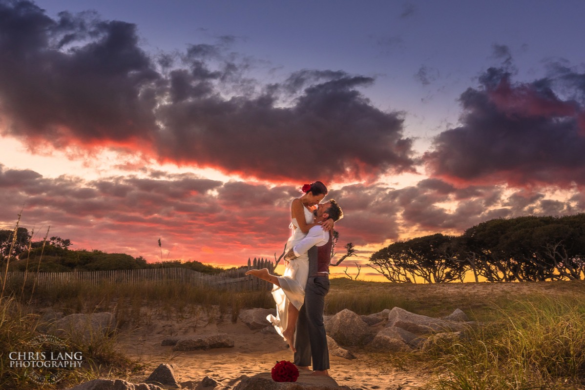 Fort Fisher Wedding Photographers - Ft Fisher Wedding Photography  - Groom picking up bride - Sunset wedding photo -   Fort Fisher North Carolina -  Wedding Photography - Wedding Ideas - Bride - Groom - Wedding Dress - Chris Lang Photography- Popular wedding location - 
