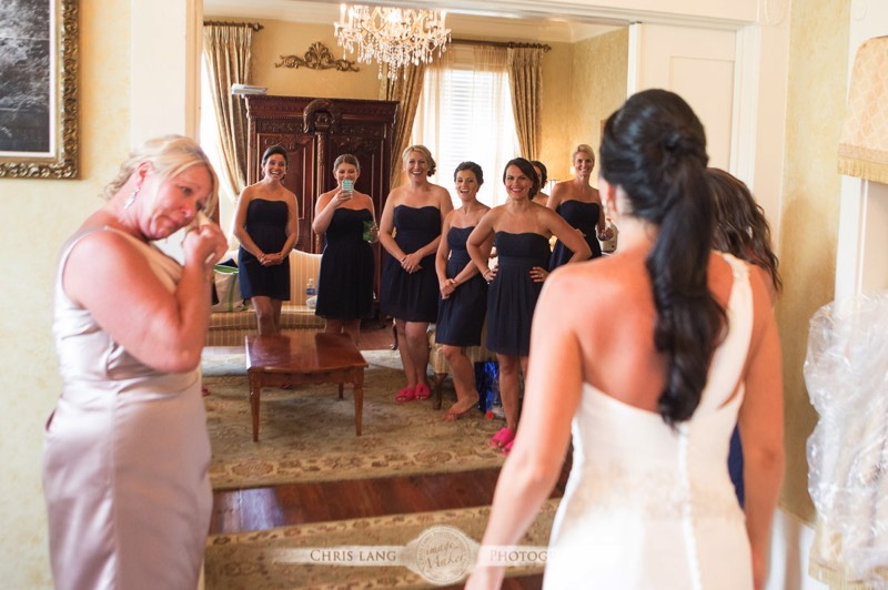 The-City-Club-Weddings-Picture of a bride standing in fron of her bridesmaids in her wedding dress 