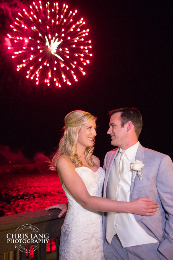 bride & groom watching the Azelea Festical fireworks from their wedding at the River Room in Wilmington NC