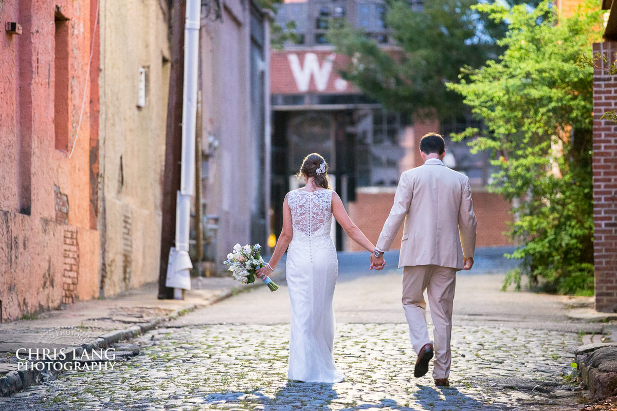 128 South Wedding & Reception Venue - Downtown Wilmington NC - Wedding Photography by Chris Lang Photography - Wedding image - wedding ideas - bride & groom walking on cobblestone
