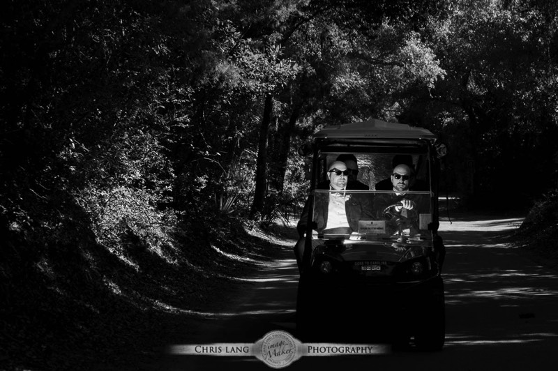 Real Weddings-Featured Wedding in Black and White-Wedding Ideas-Style-Trends-Wilmington NC Wedding Photographers-Groomsman riding on golf cart on Bald Head Island