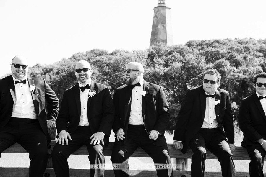 Real Weddings-Featured Wedding in Black and White-Wedding Ideas-Style-Trends-Wilmington NC Wedding Photographers- Groomsman in front of Old Baldy Light House Bald Head Island