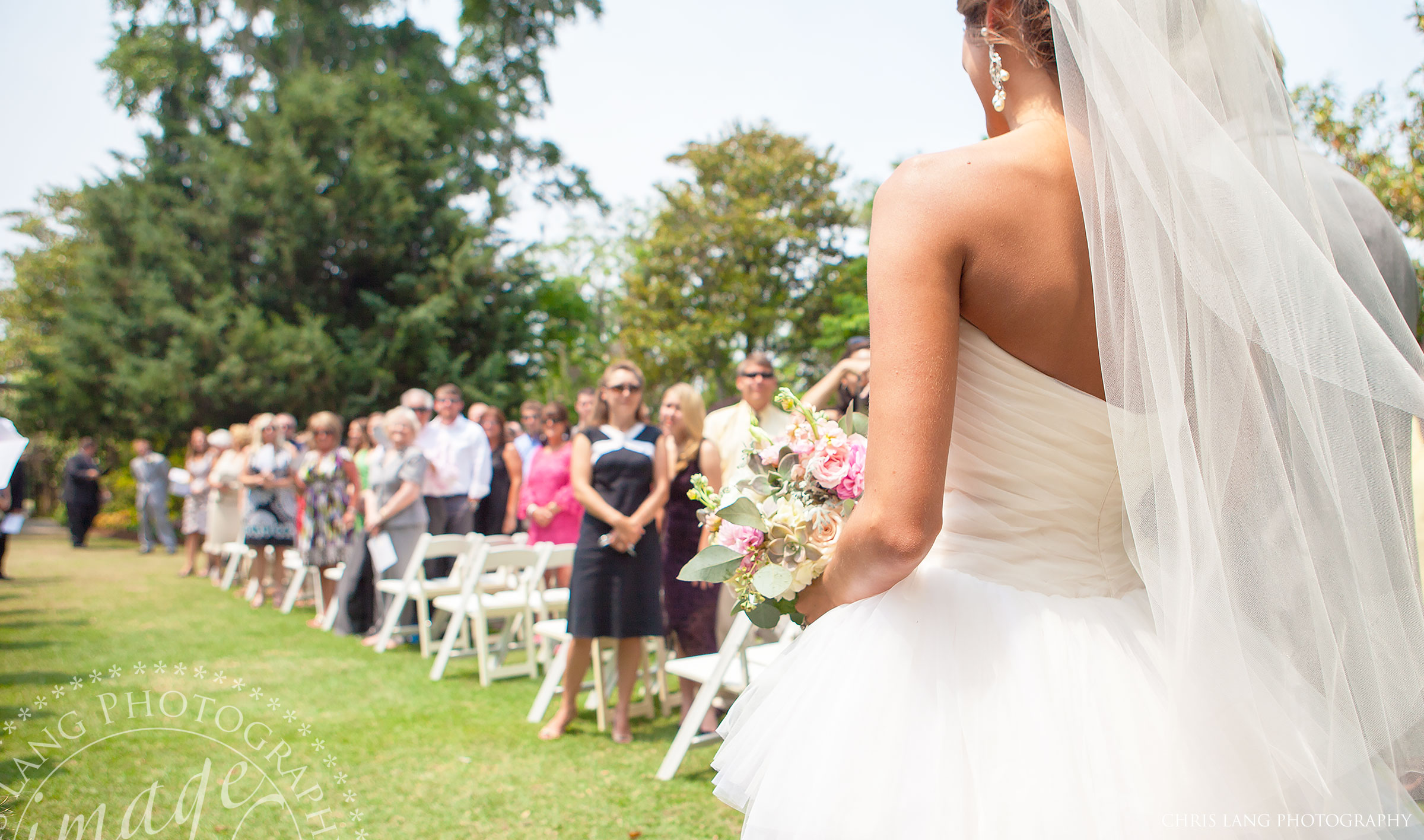 Wedding picture of of a Bride walking down the Isle at Airlie Gardens.  Airle Garden Wedding Pictures