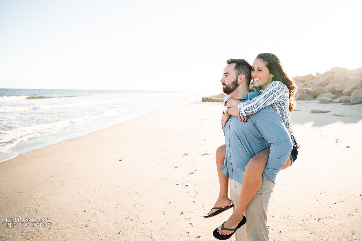 Bright and Airy Engagement photo - Couple wrapped  in Christmas lights on the beach - Fort Fisher North Carolina -  Engagement Photography - Wedding Ideas - Popular engagement photography locations - Lifestyle engagement photo -  Ft Fisher engagement photographers - Engagement session ideas - New trends in engagement photography - Chris Lang Photography - Engagement photos 