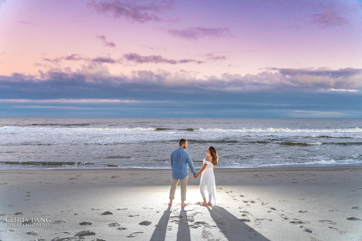 Fort Fisher Wedding Photographers  - Sunset - Couple - romance - holding hands - Fort Fisher North Carolina -  Engagement Photography - Popular engagement photography locations - Lifestyle engagement photography -  Ft Fisher engagement photographers - Engagement session ideas - Trends in engagement photography - Chris Lang Photography - Engagement photos 