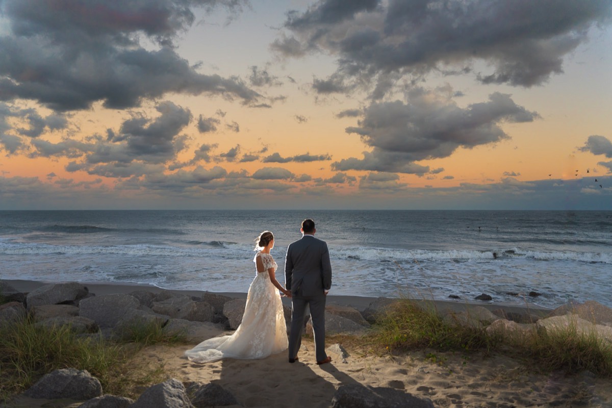 Fort Fisher Wedding Photographers - Ft Fisher Wedding Photography  - Twilight wedding photo of bride and groom  -   Fort Fisher North Carolina -  Wedding Photography - Wedding Ideas - Bride - Groom - Wedding Dress - Chris Lang Photography- Popular wedding location -  lifestyle wedding photography