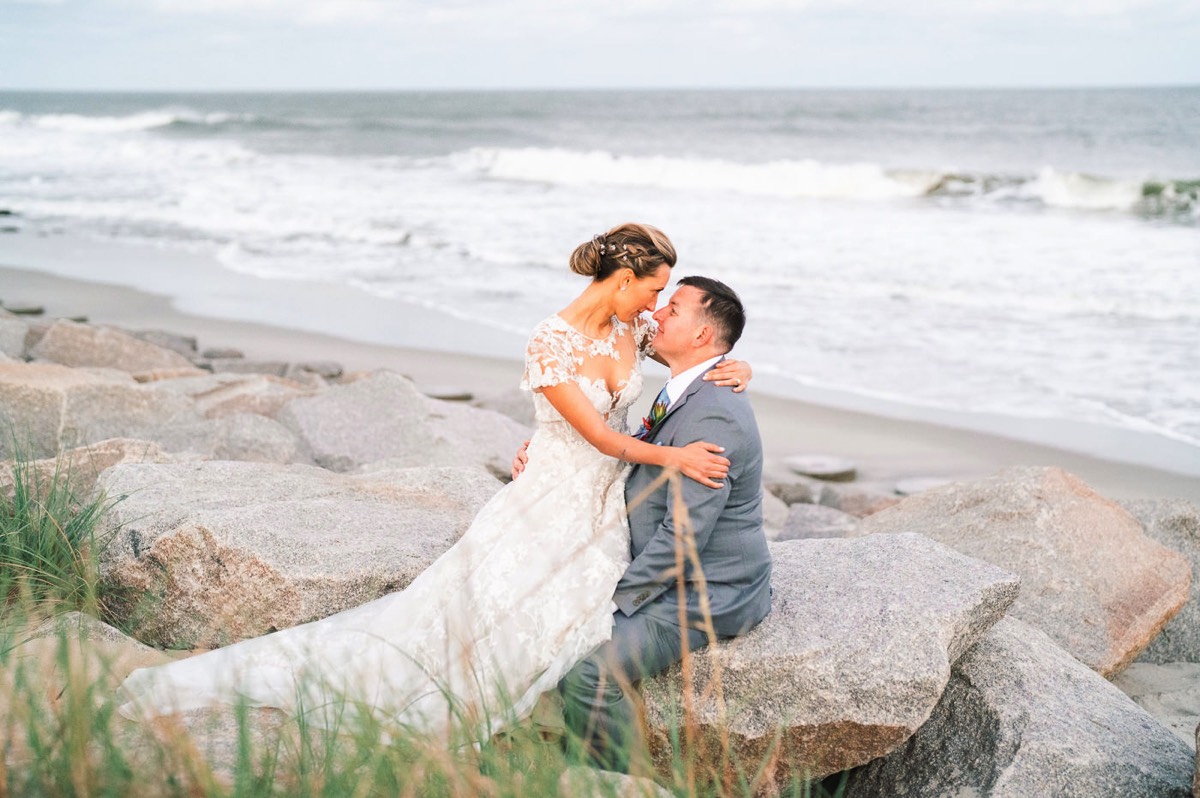 Fort Fisher Wedding Photographers - Ft Fisher Wedding Photography  - Bride & groom on the beach rocks at   Fort Fisher North Carolina -  Wedding Photography - Wedding Ideas - Bride - Groom - Wedding Dress - Chris Lang Photography- Popular wedding location - 