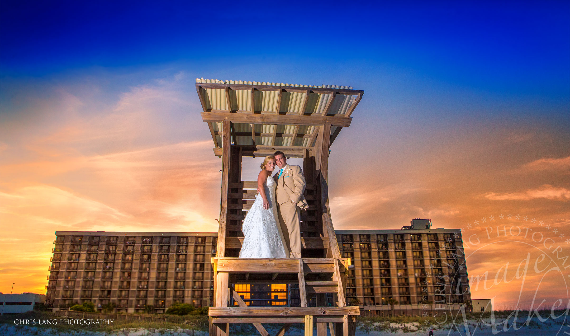 Picture of wedding couple standing on life gurad tower at the Shell Island Resort. Placed to get married on Wrightsville Beach. Wilmington NC Photographer