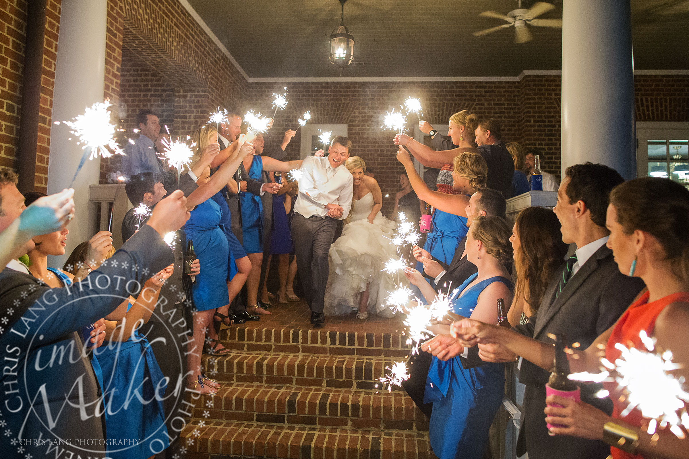 Picture of a bride and groom leaving the wedding reception by a sparkler exit at the Country Club of Landfall, Wilmington NC Wedding Photographers