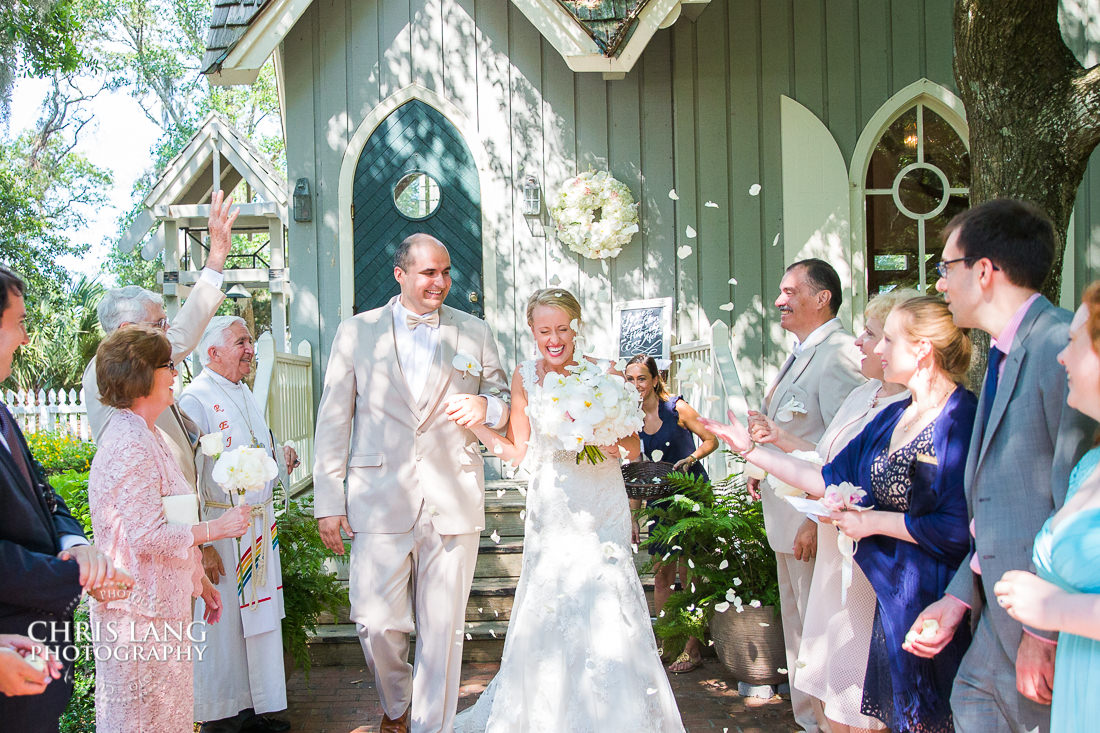 bride and grrom exiting a wedding ceremony at the village chapel of Bald Head Island - Bald Head Island NC Wedding Photographers