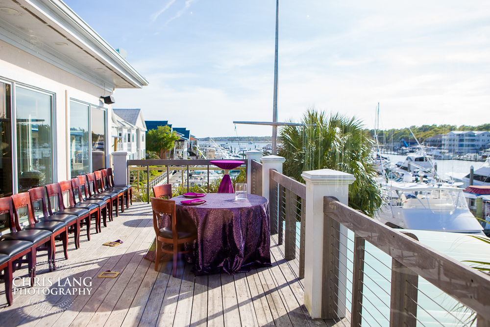 image of bride and groom table at bluewater grill overlooking to intercoastal waterway with boats in the background - Wrightsville Beach - NC