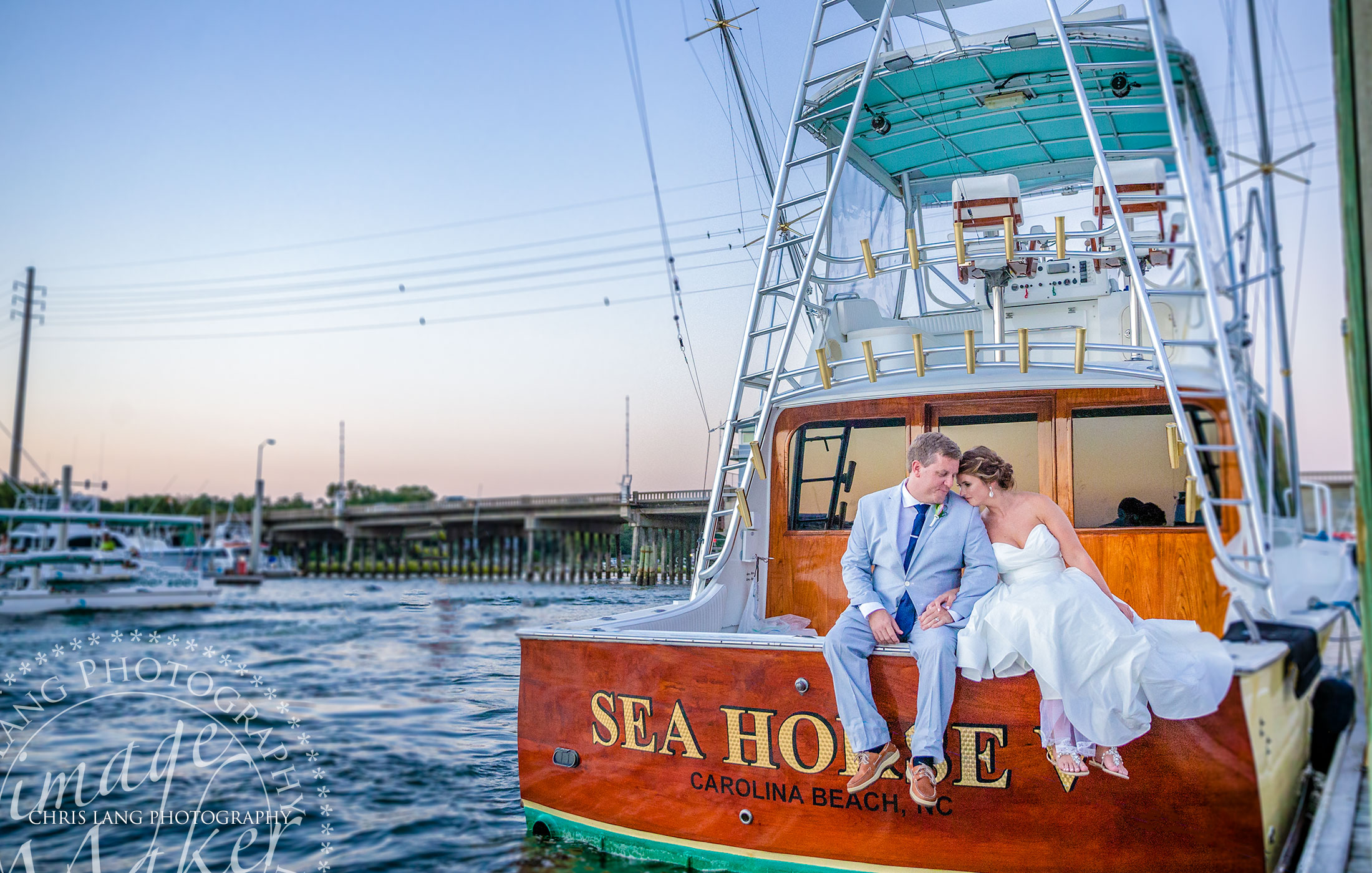 Blue Water Grill Wedding & Receptions - image of bride & groom arriving to wedding reception by Fishing Yacht