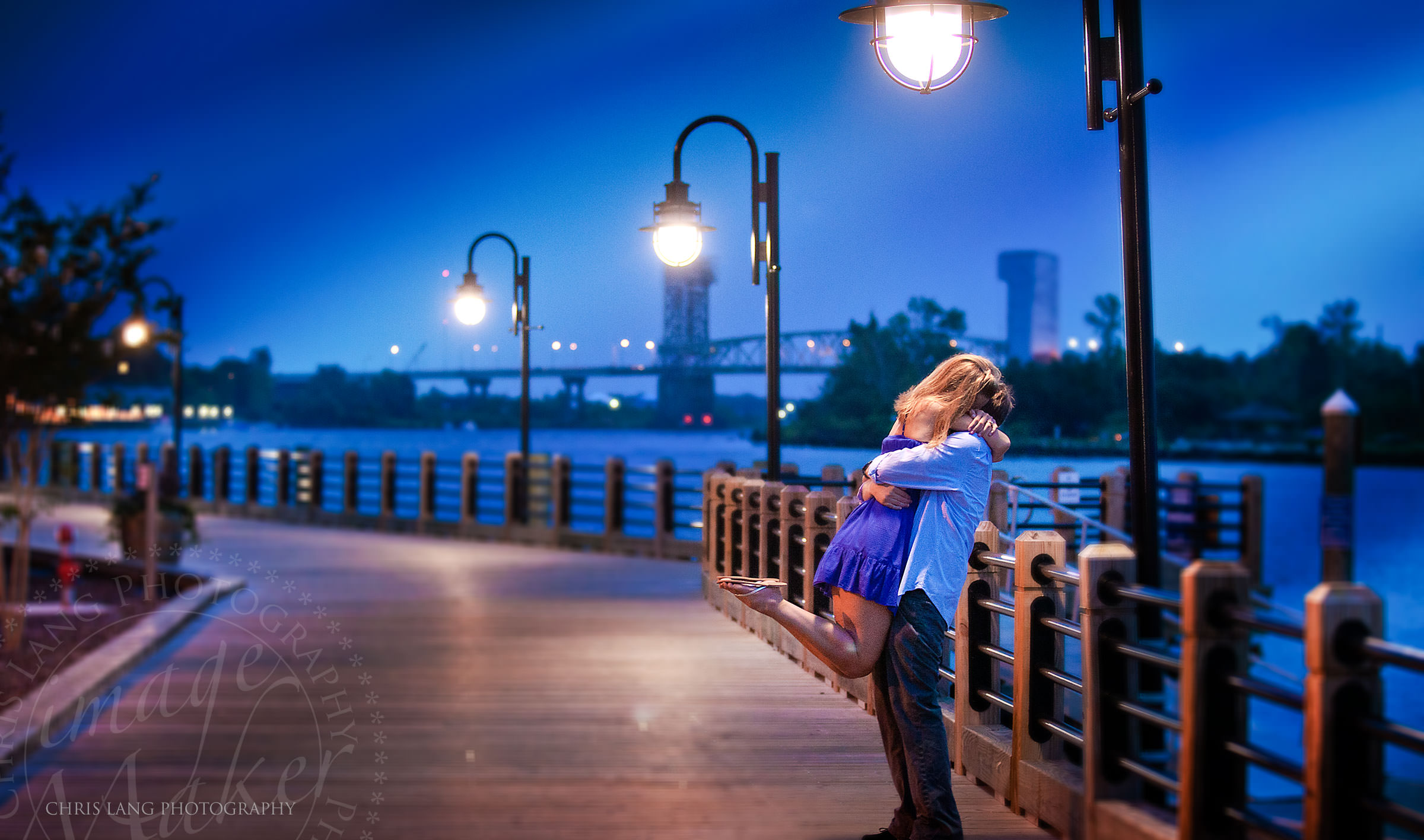 Image of engaged couple on the Cape Fear River Deck - Wilmington NC Engagement Photographers