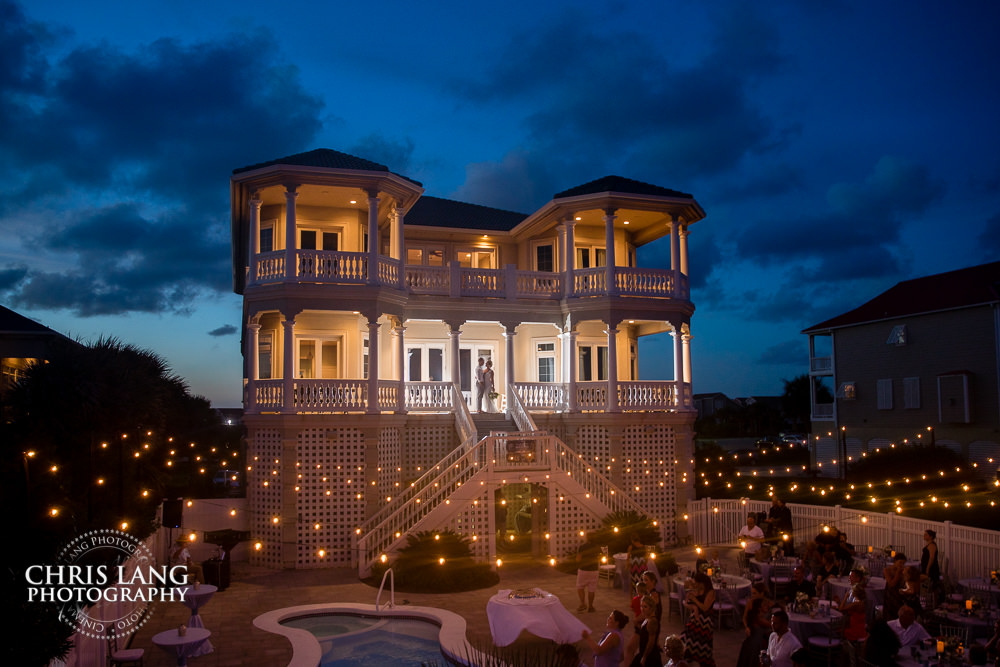 nc beach weddings - beach wedding picture - wedding ideas - beach wedding photography - Ocean Isle Beach NC Beach House Wedding - bride & groom on beach house porch at sunset