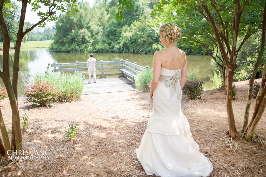 Fisrt look as Bride surprises groom at the covered bridge  in RIver Landing Country Club
