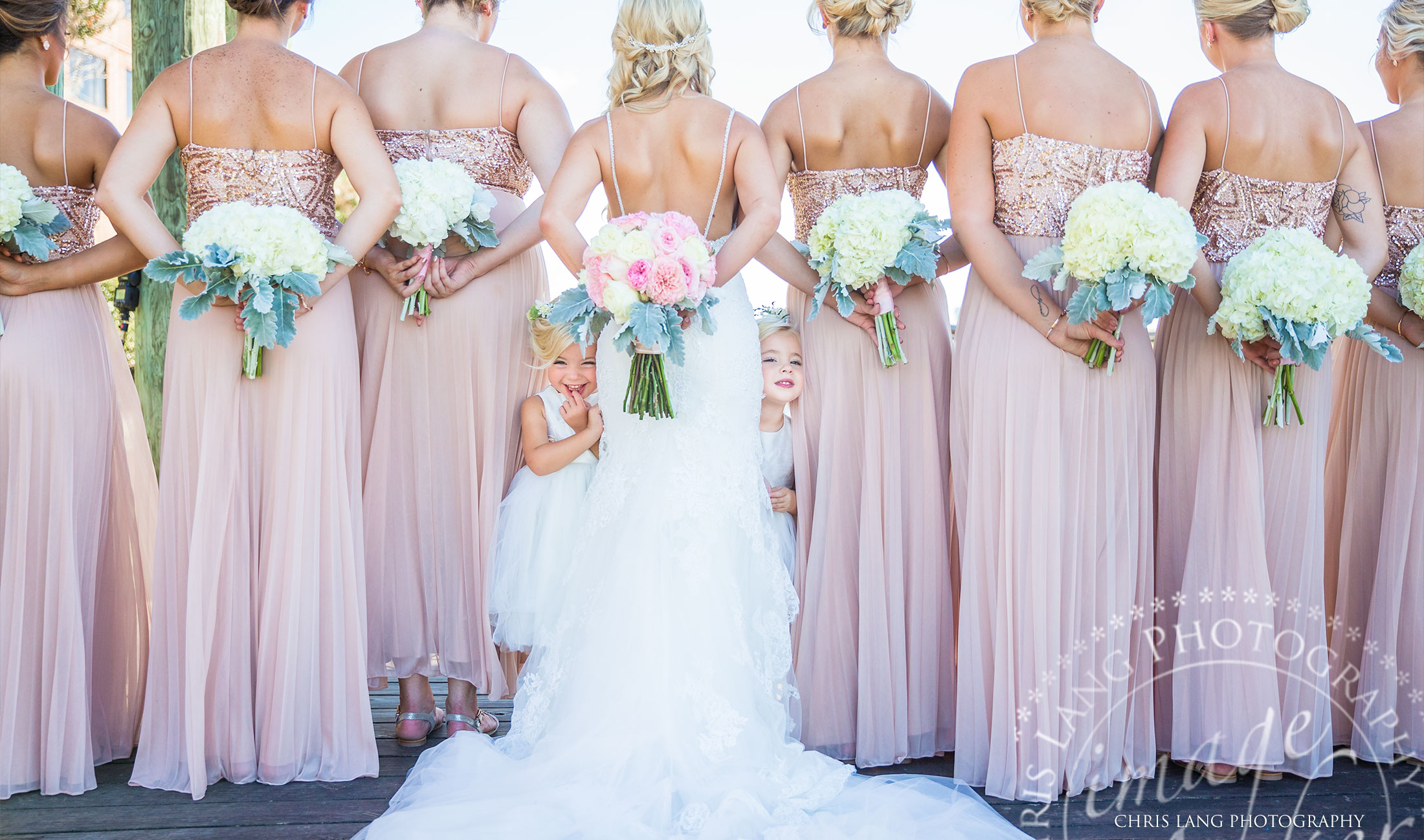 flower girls peaking behind bridsmaids - fun bridesmaid photo - bridesmaid dresses - bridal boguets - 