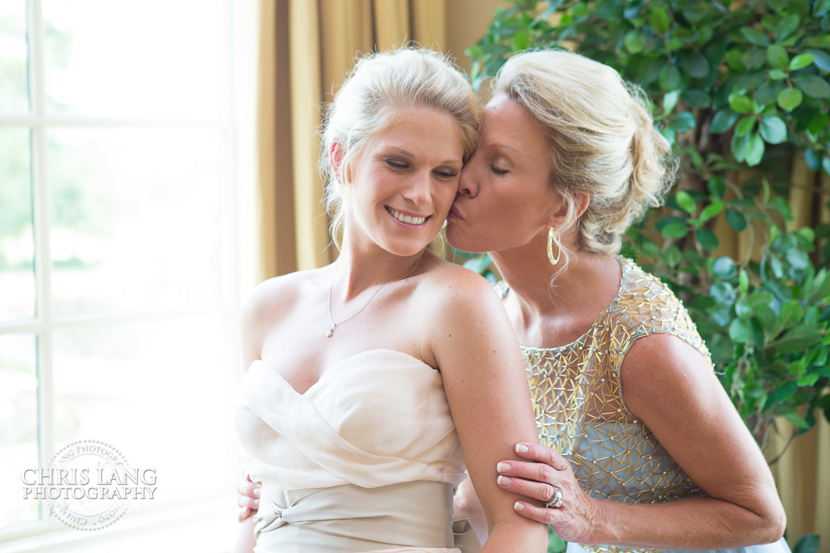 mom giving bride  a kiss before the wedding - river landing wedding venue - pre wedding photos - wedding photo ideas - getting ready wedding pictures - bride - groom - wedding dress - wedding detail photos - river landing wedding photography