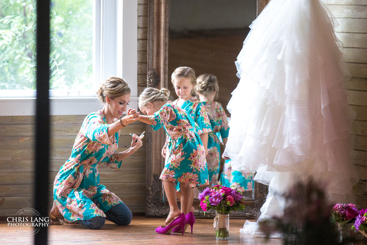 cute phot of flower girl wearing the brides shoes - pre wedding photos - wedding photo ideas - getting ready wedding pictures - bride - groom - wedding dress - wedding detail photos - wilmington nc wedding photographers