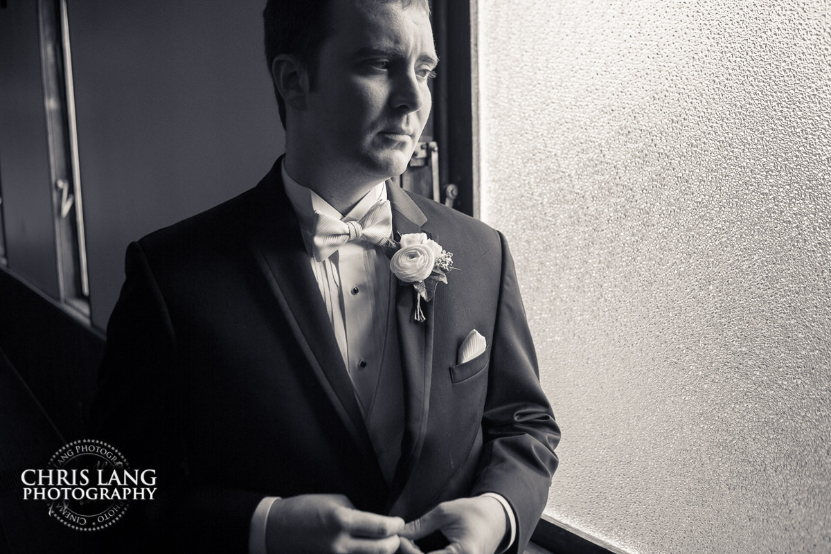 groom putting on jacket - pre wedding photos - wedding photo ideas - getting ready wedding pictures - bride - groom - wedding dress - wilmington nc wedding photography  