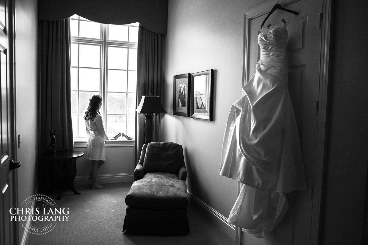 bride in robe with wedding dress  - pre wedding photos - wedding photo ideas - getting ready wedding pictures - bride - groom - wedding dress - wilmington nc wedding photography  