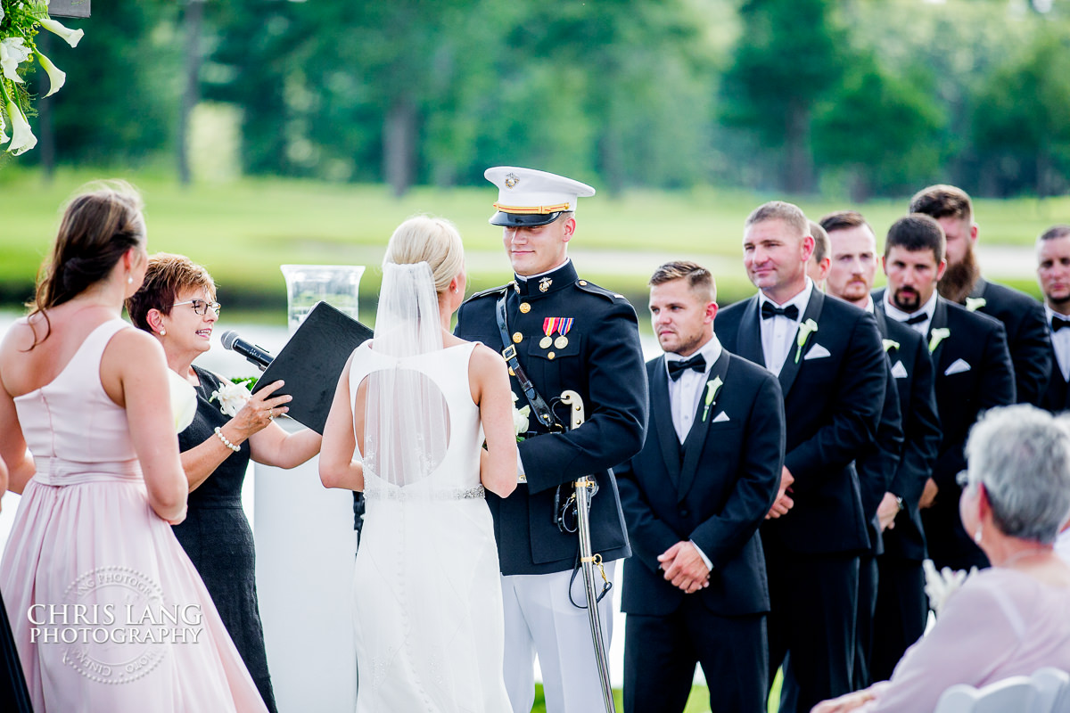 bride & groom at alter - outdoor weddings -  wedding ceremony photo - wedding ceremonies - bride - groom - bridal party - wedding ceremony photography - ideas - wilmingotn nc wedding photography 