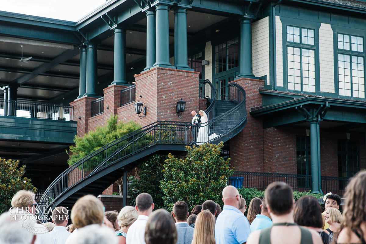 bride walking down sprial staircase at River Landing - Wallace NC - wedding ceremony photo - wedding ceremonies - bride - groom - bridal party - wedding ceremony photography - ideas 