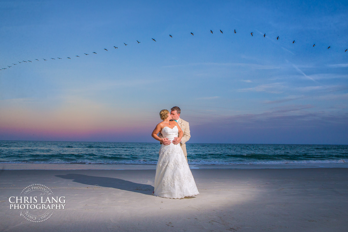 wrightsvile beach nc weddings - destination weddings - beach weddings - sunset wedding photo - the golden hour - bride & groom - wedding dress - sunset wedding photography - twlight on the beach
