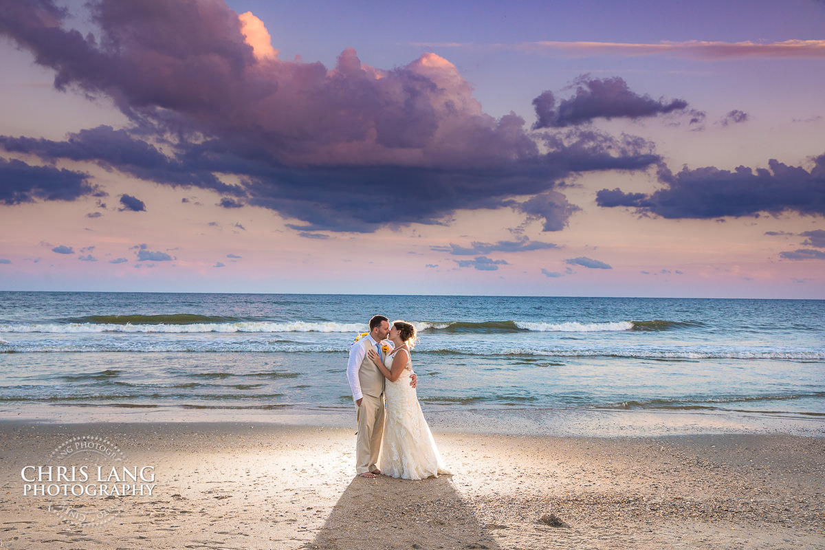 destination weddings - beach weddings - sunset wedding photo - the golden hour - bride & groom - wedding dress - sunset wedding photography - twlight on the beach - Ocean Isle Beach nc weddings