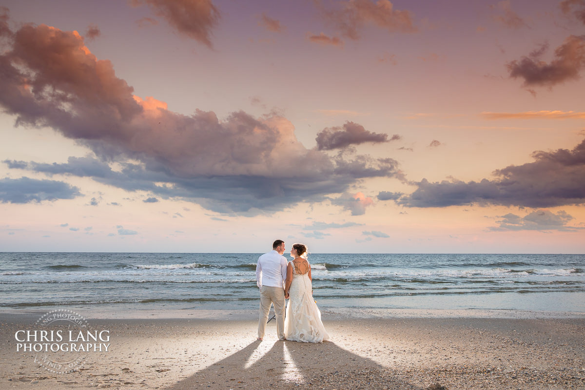 Oak Island NC Weddings - beach weddings - sunset wedding photo - the golden hour - bride & groom - wedding dress - sunset wedding photography - twlight on the beach - destination wedding