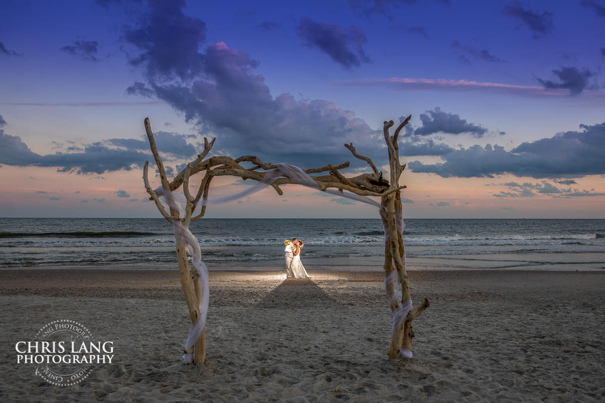 Fort Fisher NC Beach Weddings - beach weddings - sunset wedding photo - the golden hour - bride & groom - wedding dress - sunset wedding photography - twlight on the beach 