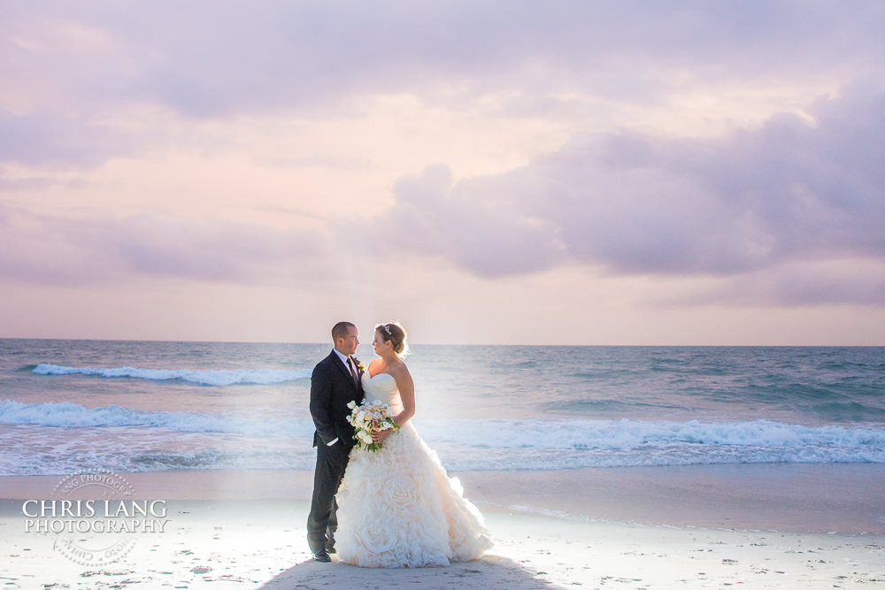 shoals club weddings - bald head island - destination weddings - beach weddings - sunset wedding photo - the golden hour - bride & groom - wedding dress - sunset wedding photography - twlight on the beach