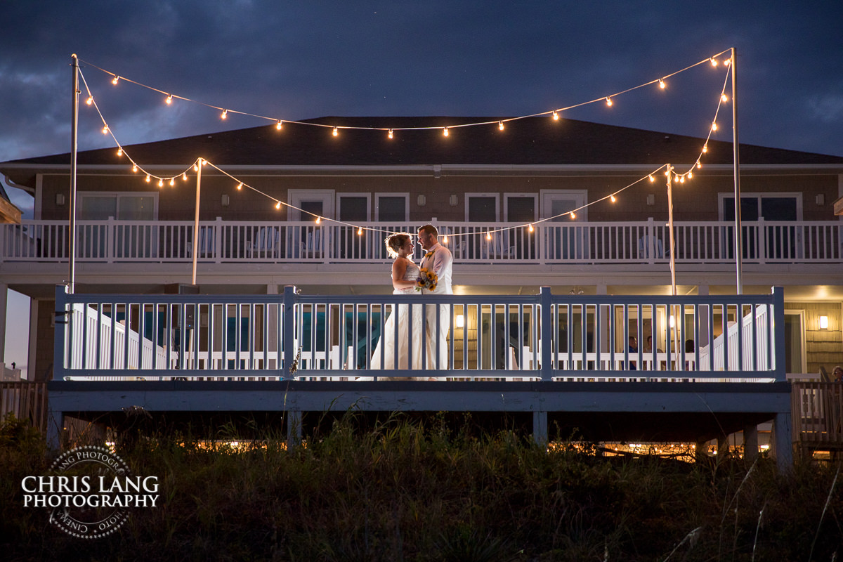 beach house weddings - beach weddings - sunset wedding photo - the golden hour - bride & groom - wedding dress - sunset wedding photography - twlight on the beach - OceanIsle Beach NC