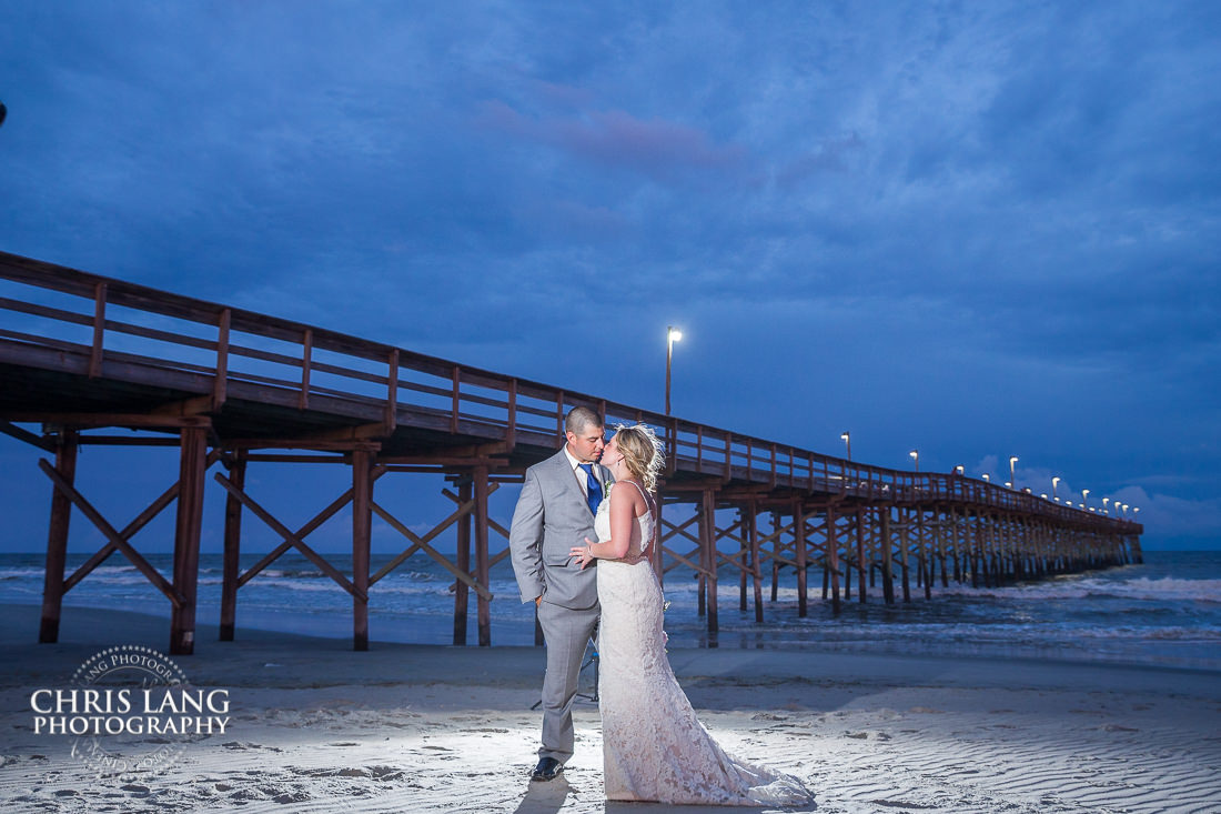 ocean isle pier -ocean isle beach weddings - beach weddings - sunset wedding photo - the golden hour - bride & groom - wedding dress - sunset wedding photography - twlight on the beach