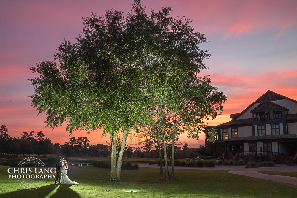 bride and groom under oak tree -sunset wedding photo - the golden hour - bride & groom - wedding dress - sunset wedding photography - twlight - wilmington nc wedding photography