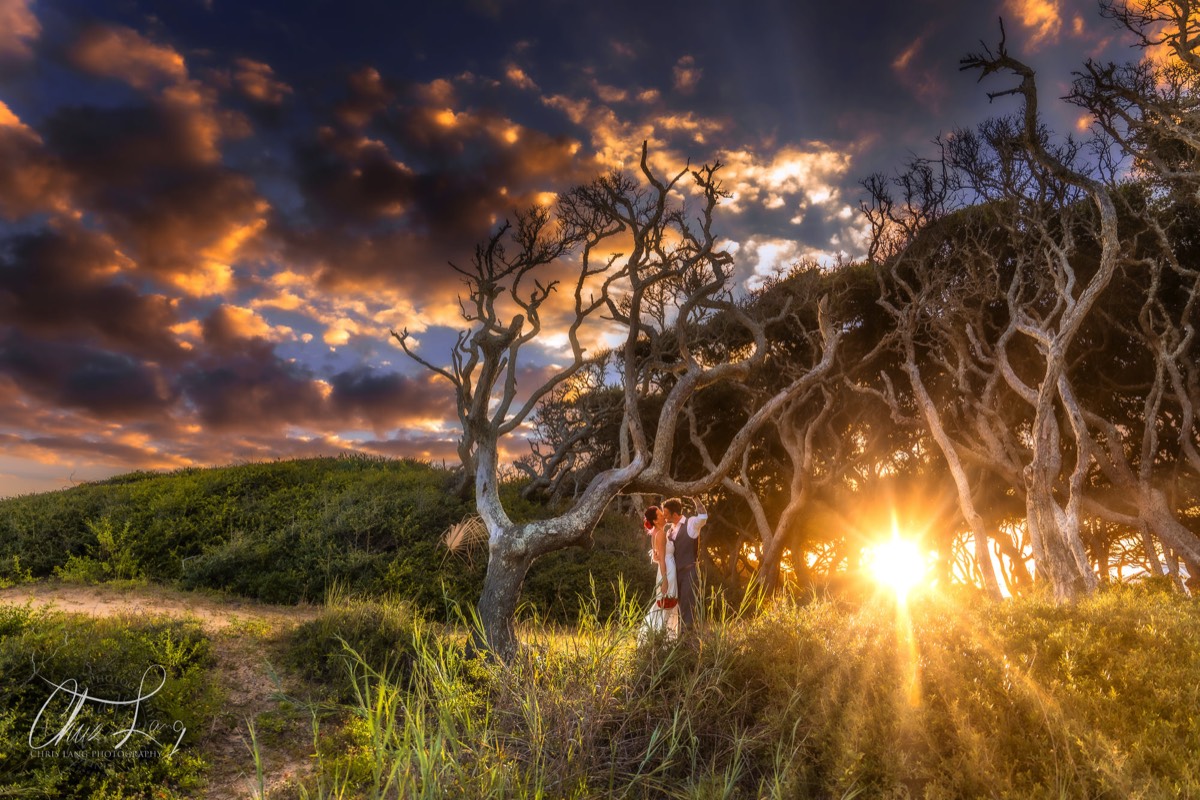 creative wedding photo at ft fisher - sunset - wilmington nc wedding photographers - creative wedding photo - signature portrats - wedding ideas - bride - groom - wedding dress - chris lang photography