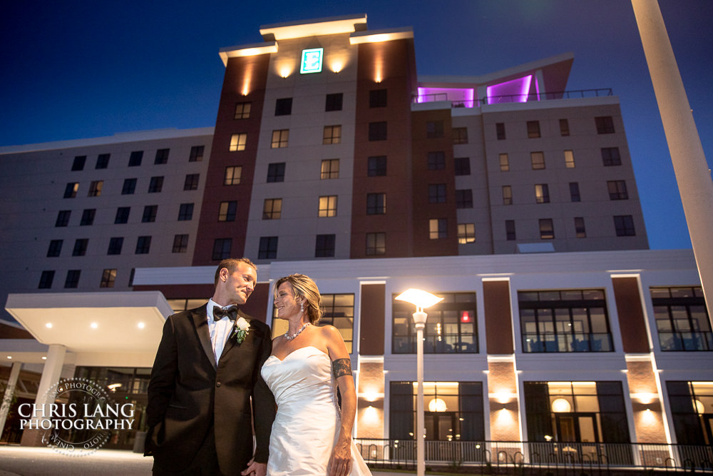 bride & groom outside the front of embassy suites by hilton - wilmingotn nc - wedding photo - wedding reception - wedding decor - wedding and event venues - 