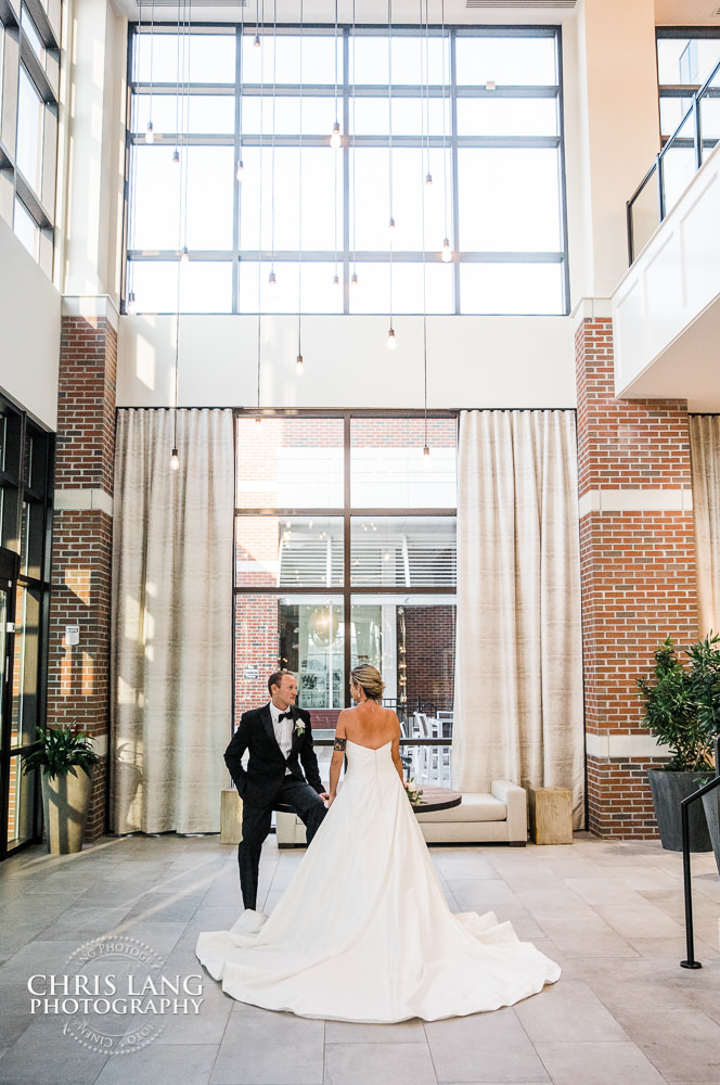 bride & grrom inside of the lobby at embassy suites by hilton - wilmington nc - wedding photo - wedding reception - wedding decor - wedding and event venues - 
