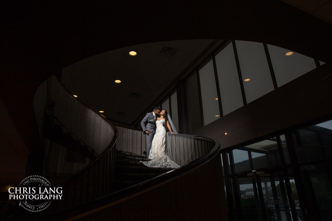 bride and groom on the spiral starcase at Hotel Ballast - Wilmington NC - Wedding & Reception Venue - Wedding Photography - Bride - Groom - Chris Lang Photography 