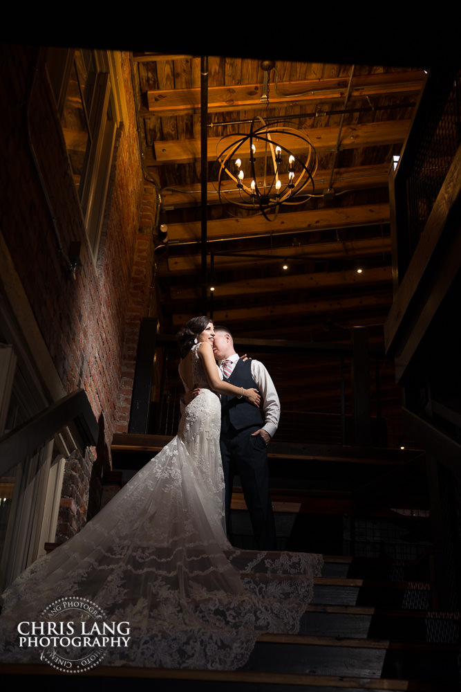 bride & groom on the staircase at ironclad brewery - wedding photo - wedding photography - wedding & reception ideas - 