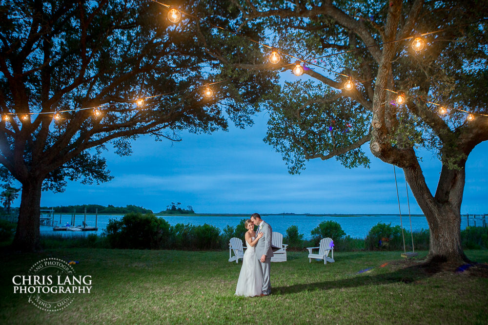 sunset wedding photo - oak trees - edisson lighting - marker 137 wedding venue - wilmington nc- wedding photography - bride - groom-  wedding photographers  - outdoor wedding venue - wedding photo ideas