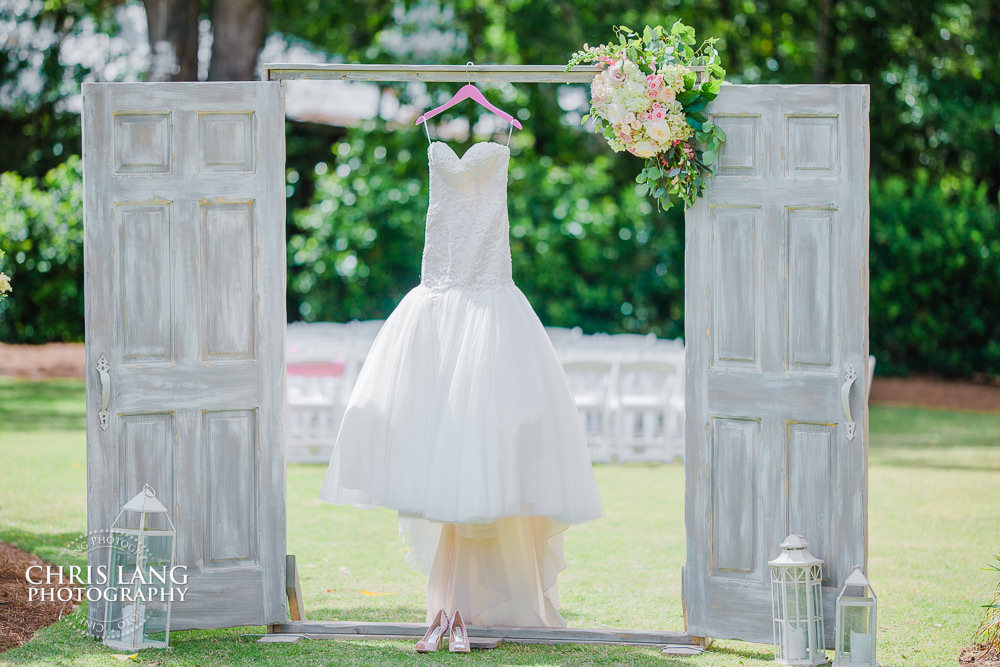 Wedding dress photo - wedding dress hanging from barn doors - natural light wedding photo - wedding photography ideas - Wilmington NC Wedding Photography