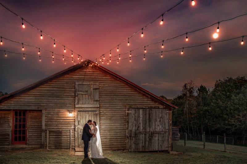 Barn wedding - bride and groom under edison ligting - twilight wedding photo - wilmington nc wedding photographer - wedding photo - bride - groom - wedding dres - wedding ideas - chris lang photography