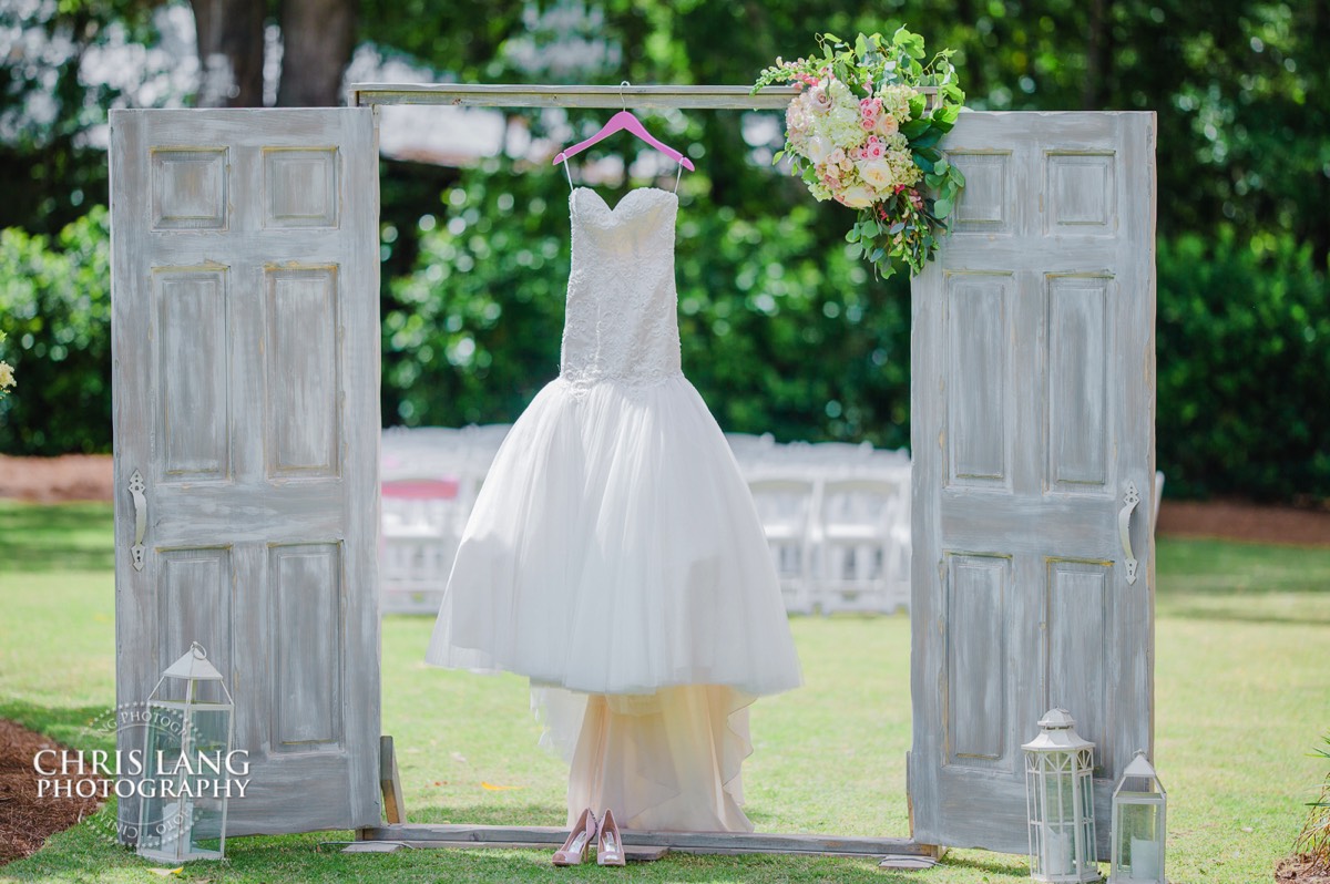 wedding dress haging outside on wedding doors at Wrightsville Manor in Wilmington NC - Wedding Venues - Wedding Photography