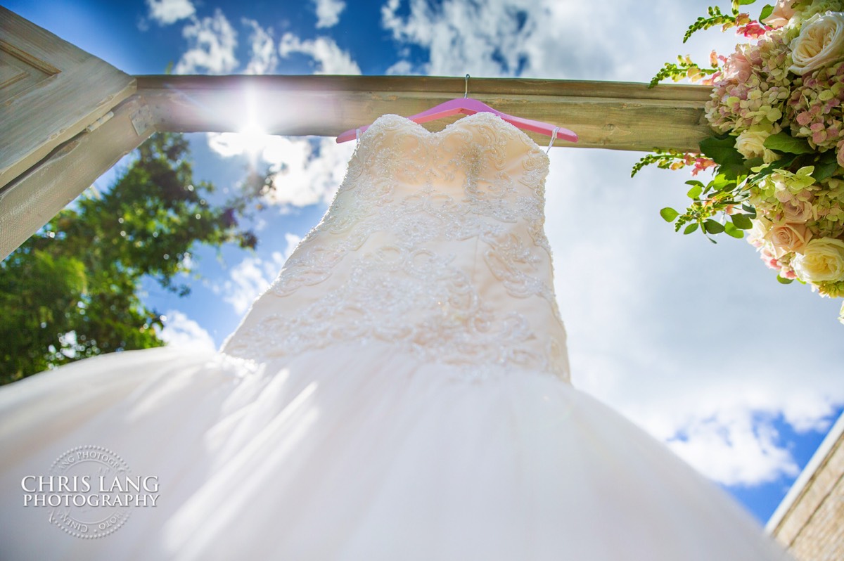 Wedding dress hangin outside on barn doors at Wrightsville Manor - Wilmington NC - Wedding details