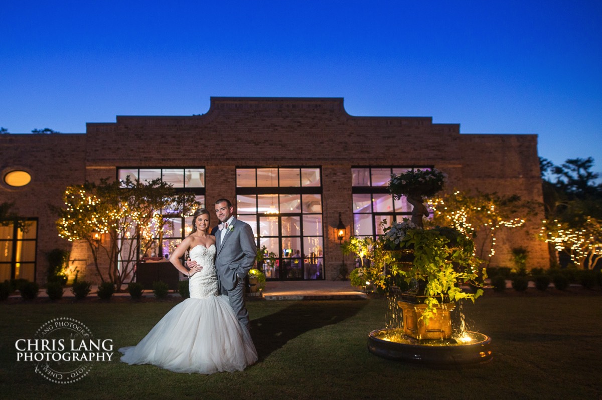 Wrightsville Manor- Wilmington NC - image of  wedding couple in fron of Wrightsville Manor at sunset - Wrightsvile Manor Wedding Photography 
